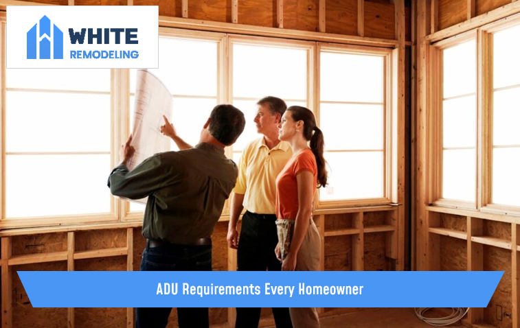 Man explaining ADU requirements to a couple in an under-construction home