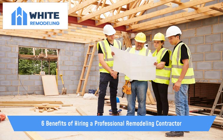 Professional remodeling contractors reviewing plans at a construction site