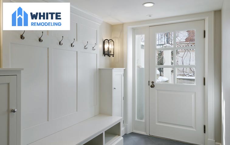 Functional and elegant mudroom featuring a bench and coat rack