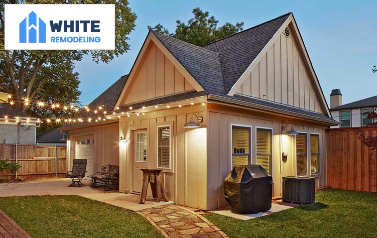 Exterior view of a house with a garage addition, showcasing an expanded space