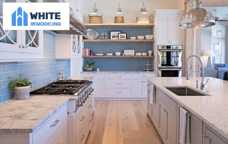 Modern kitchen with open shelves displaying neatly organized dishes and decor.